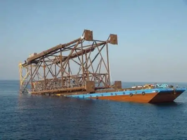 Wellhead jacket on a launch barge at sea